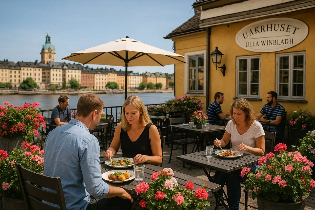 Wärdshuset Ulla Winbladh terrace in summer with flower-filled tables and traditional Swedish lunch plates